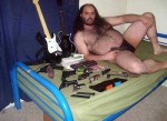 fat_hairy_guy_on_bed_with_guns